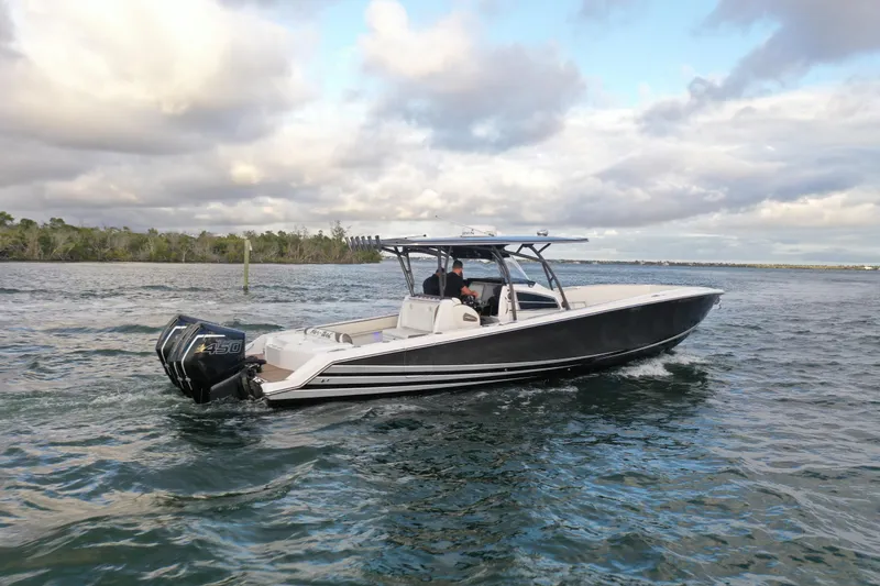 Slide: The Image of 2021 Nor-Tech 390 Sport Center Console boat cruising on open water. - 5