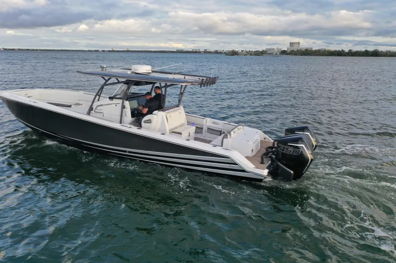 Slide: The Image of 2021 Nor-Tech 390 Sport Center Console boat cruising on open water. - 6