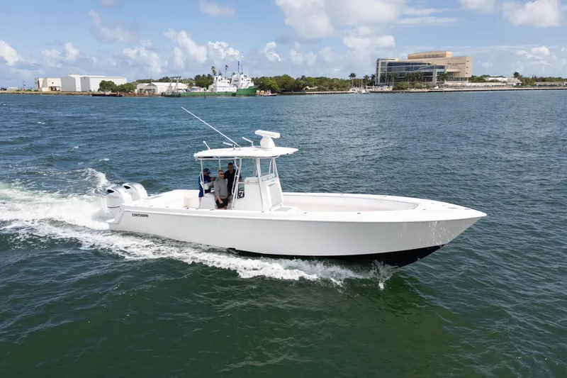 The Image of 2014 Contender 35 ST boat cruising on open water under a clear sky. - 0