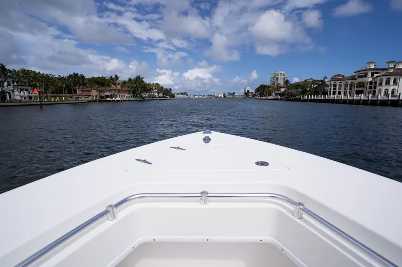 Slide: The Image of Bow view of 2014 Contender 35 ST boat cruising on a scenic waterway. - 11