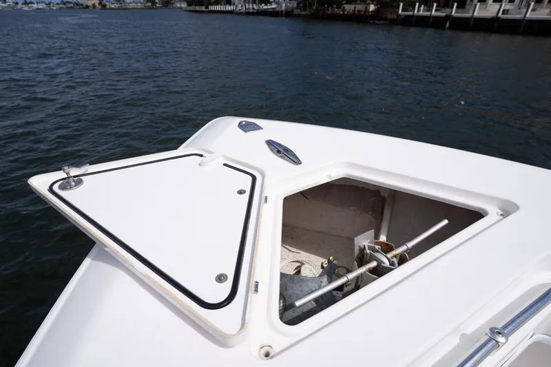 Slide: The Image of Open anchor hatch on 2014 Contender 35 ST boat, docked by the water. - 12