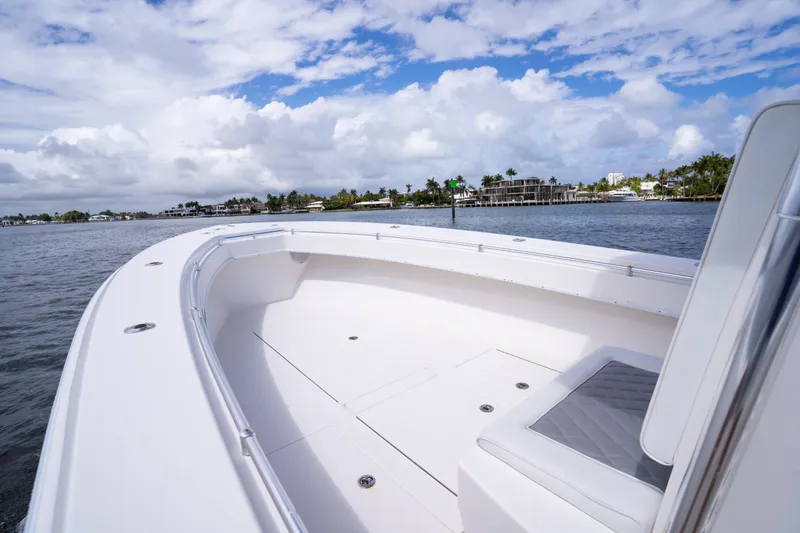 Slide: The Image of 2014 Contender 35 ST boat on calm waters under a partly cloudy sky. - 15