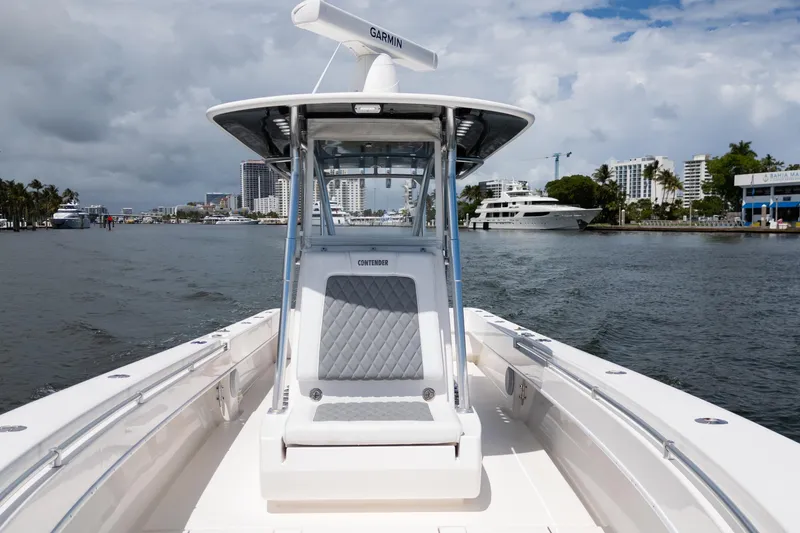 Slide: The Image of 2014 Contender 35 ST boat cruising in a scenic waterfront cityscape. - 17