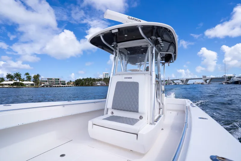 Slide: The Image of 2014 Contender 35 ST boat on water, featuring sleek design and Garmin equipment. - 18