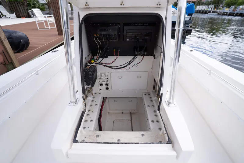 Slide: The Image of 2014 Contender 35 ST boat console with exposed wiring and Garmin electronics. - 20