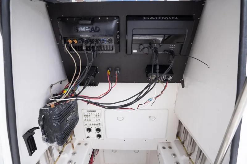 Slide: The Image of 2014 Contender 35 ST boat electronics panel with Garmin and Simrad systems. - 21