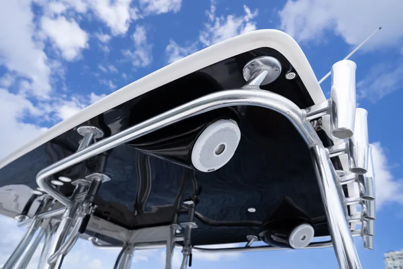 Slide: The Image of 2014 Contender 35 ST boat's T-top with speakers and rod holders against blue sky. - 26