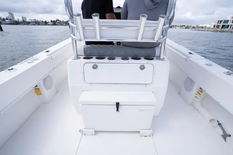 Slide: The Image of 2014 Contender 35 ST boat interior with seating and storage, cruising on water. - 28
