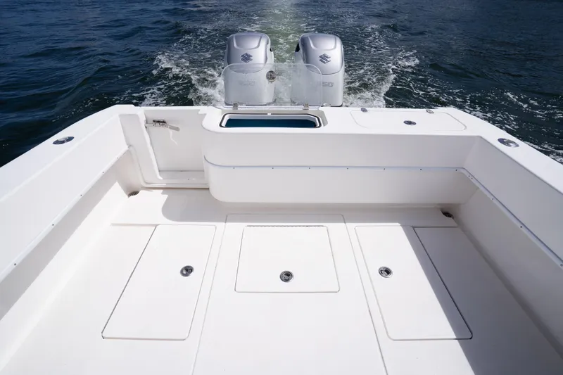 Slide: The Image of 2014 Contender 35 ST boat deck with dual outboard motors on open water. - 29