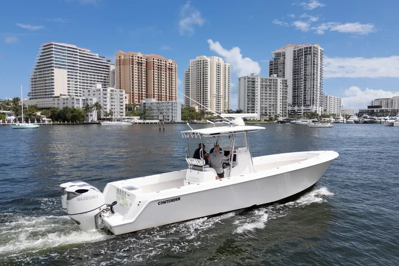 Slide: The Image of 2014 Contender 35 ST boat cruising near city skyline on a sunny day. - 3