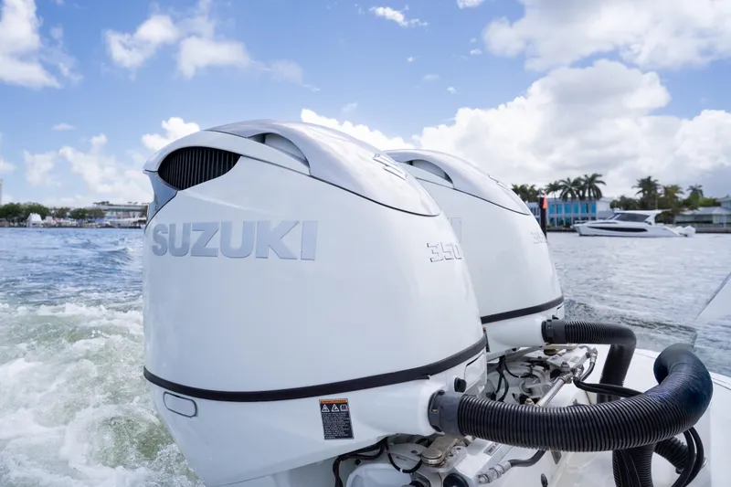 Slide: The Image of Twin Suzuki outboard motors on a 2014 Contender 35 ST boat, cruising on a sunny day. - 32