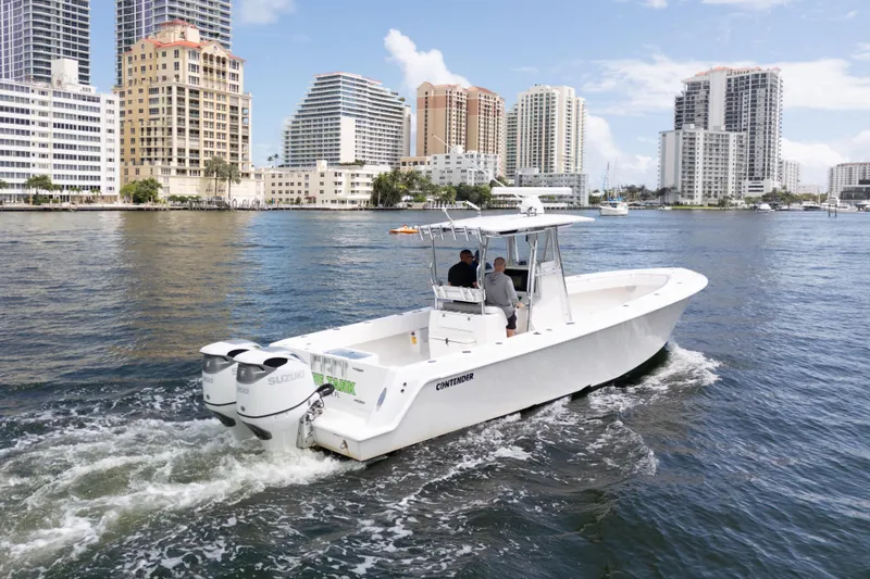 Slide: The Image of 2014 Contender 35 ST boat cruising in urban waterfront setting with skyscrapers. - 4