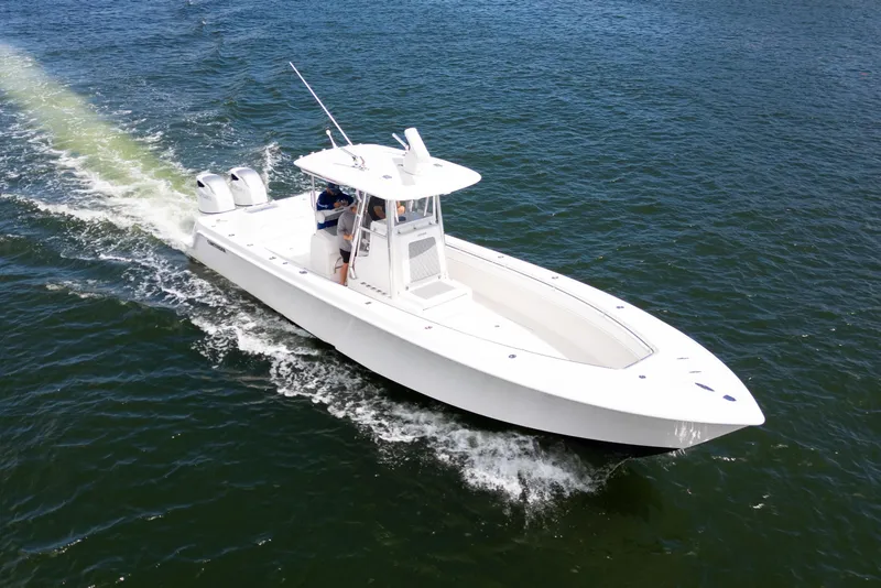 Slide: The Image of 2014 Contender 35 ST boat cruising on open water, showcasing sleek design and twin engines. - 5