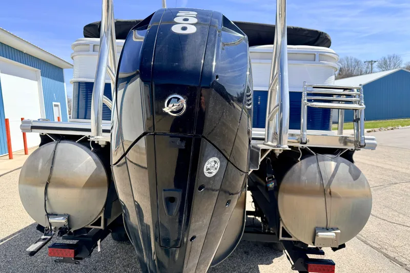 Slide: The Image of 2019 Crestliner 240 Rally DX CW boat with powerful outboard motor, docked outdoors. - 13