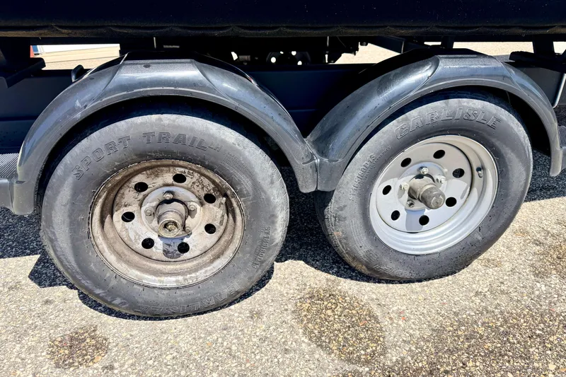 Slide: The Image of Trailer wheels of a 2019 Crestliner 240 Rally DX CW, featuring Sport Trail and Carlisle tires. - 14