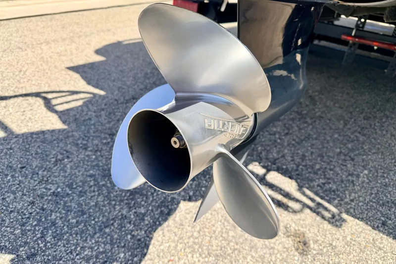 Slide: The Image of Close-up of a 2019 Crestliner 240 Rally DX CW boat propeller on pavement. - 17