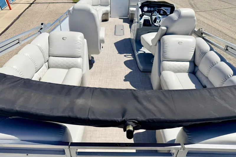Slide: The Image of 2019 Crestliner 240 Rally DX CW pontoon boat with plush seating and modern dashboard. - 21