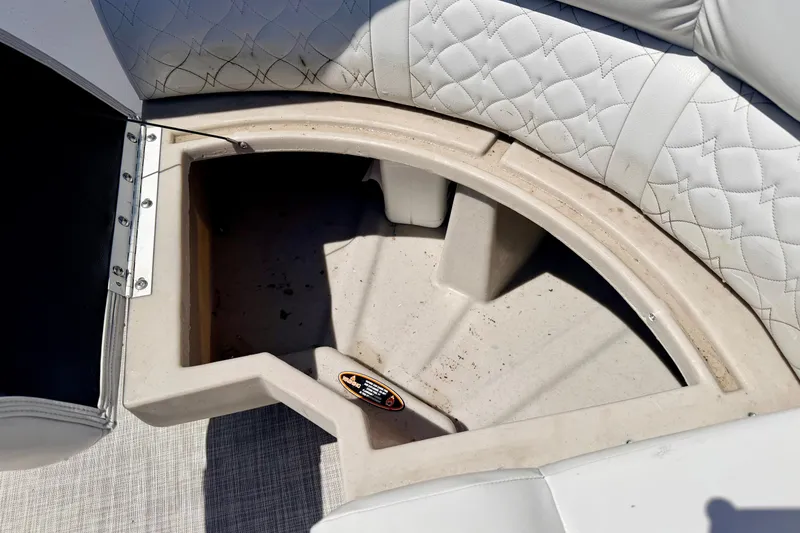 Slide: The Image of Storage compartment in 2019 Crestliner 240 Rally DX CW boat with quilted white seating. - 24