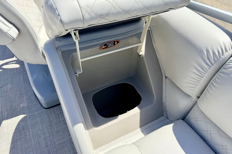 Slide: The Image of 2019 Crestliner 240 Rally DX CW boat seat with storage compartment open. - 28