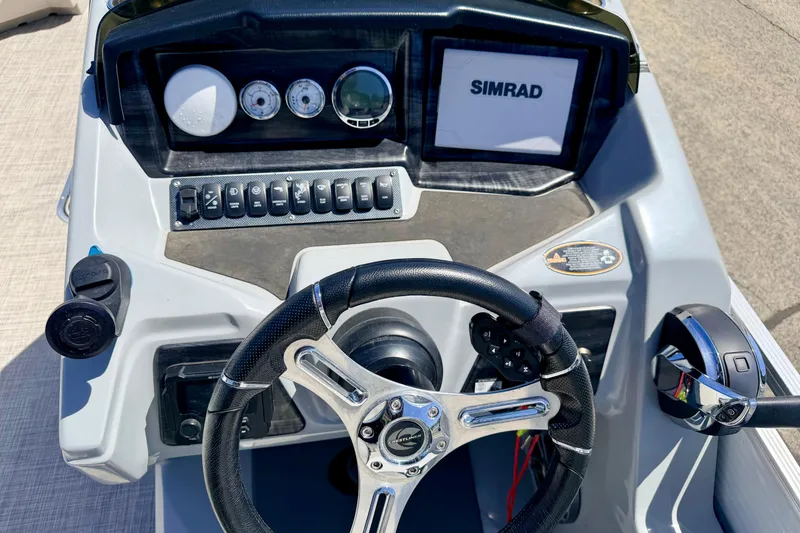 Slide: The Image of Steering console of 2019 Crestliner 240 Rally DX CW with Simrad display and controls. - 33