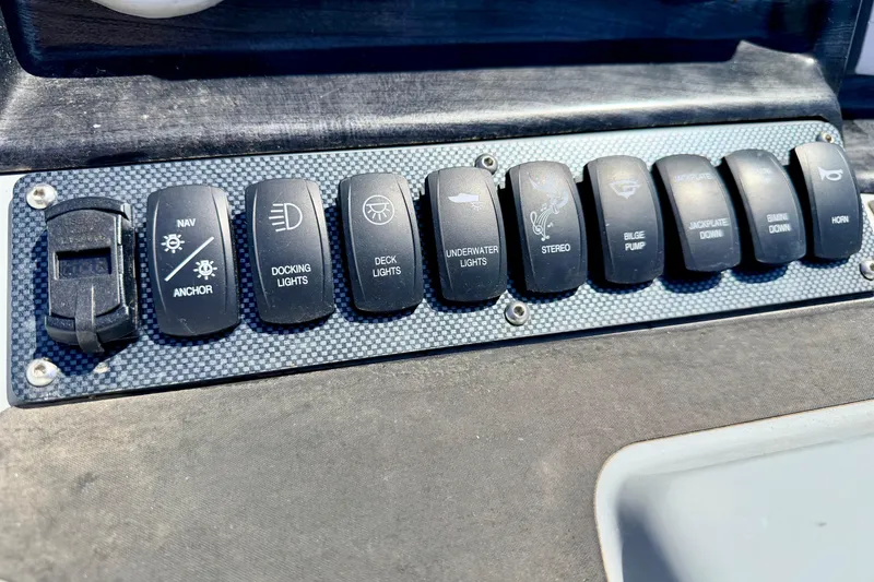 Slide: The Image of Control panel of a 2019 Crestliner 240 Rally DX CW boat with labeled switches. - 35