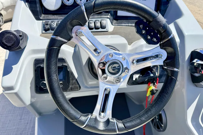 Slide: The Image of Steering wheel of 2019 Crestliner 240 Rally DX CW boat, featuring sleek design and controls. - 37