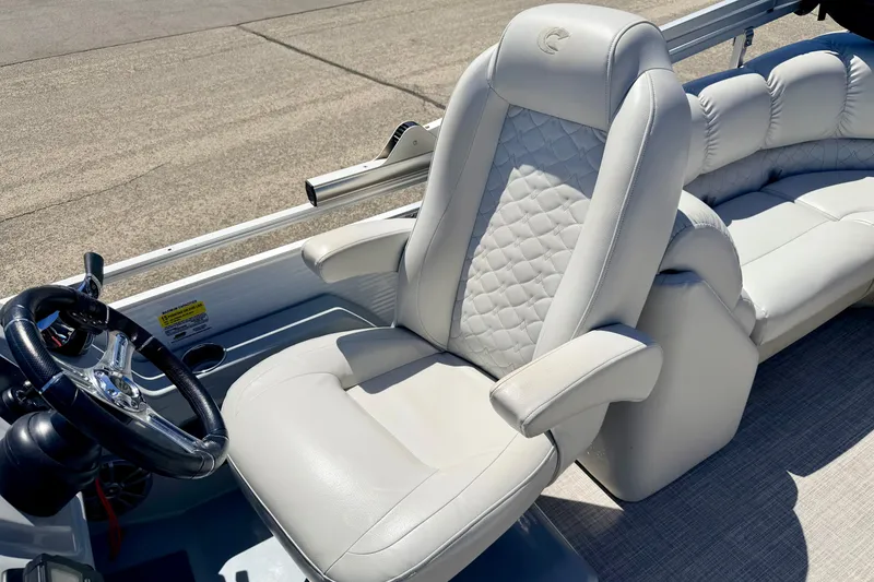 Slide: The Image of 2019 Crestliner 240 Rally DX CW boat interior with plush seating and steering wheel. - 43