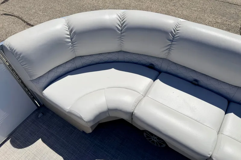 Slide: The Image of 2019 Crestliner 240 Rally DX CW boat with plush, curved seating in light gray upholstery. - 45