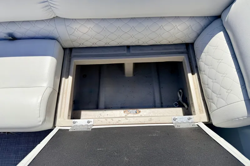 Slide: The Image of Open storage compartment in 2019 Crestliner 240 Rally DX CW boat with cushioned seating. - 48