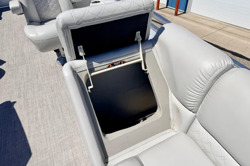Slide: The Image of 2019 Crestliner 240 Rally DX CW boat seat with open storage compartment, showcasing quilted upholstery. - 53