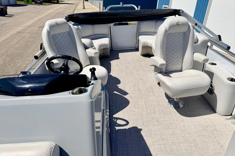 Slide: The Image of 2019 Crestliner 240 Rally DX CW pontoon boat interior with plush seating and steering console. - 60