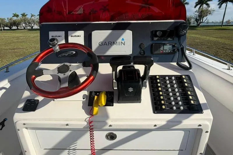 Slide: The Image of 1992 Baja 280 Sportfish dashboard with Garmin navigation and Suzuki controls. - 10