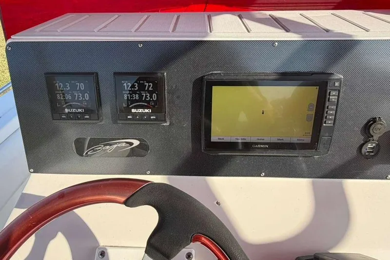 Slide: The Image of Dashboard of a 1992 Baja 280 Sportfish with Suzuki and Garmin displays. - 11