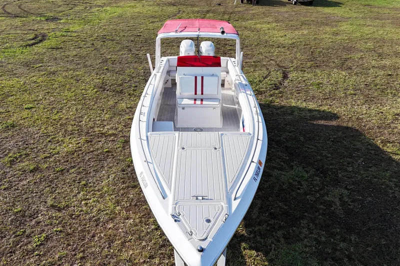 Slide: The Image of 1992 Baja 280 Sportfish boat with red canopy on grassy terrain. - 4