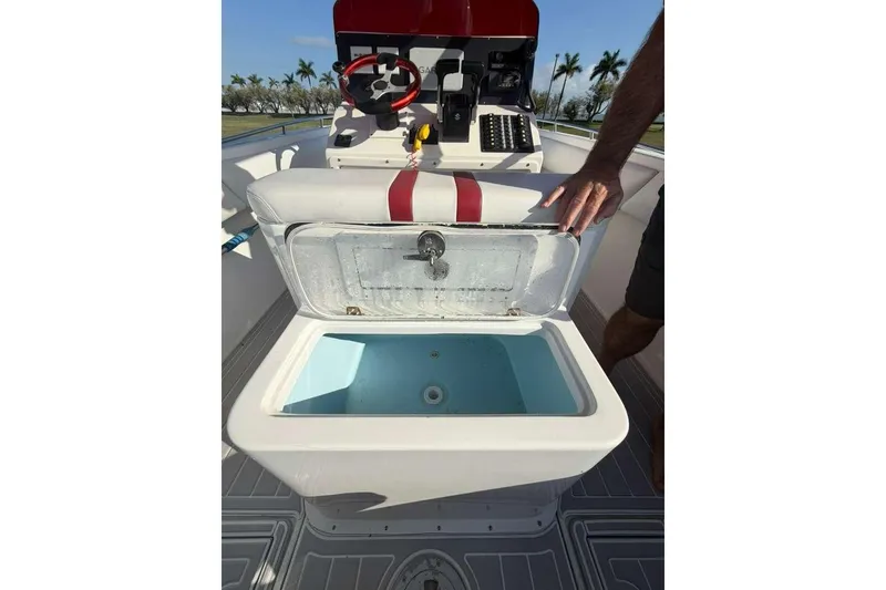 Slide: The Image of 1992 Baja 280 Sportfish boat with open storage compartment and steering console. - 9