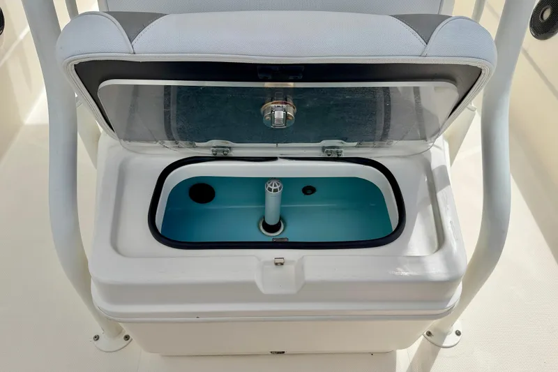 Slide: The Image of 2018 Skeeter SX2250 boat livewell with open lid and blue interior. - 10