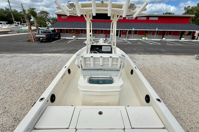 Slide: The Image of 2018 Skeeter SX2250 boat with center console, parked near a red building. - 11