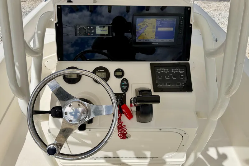 Slide: The Image of 2018 Skeeter SX2250 boat console with steering wheel, controls, and navigation display. - 13
