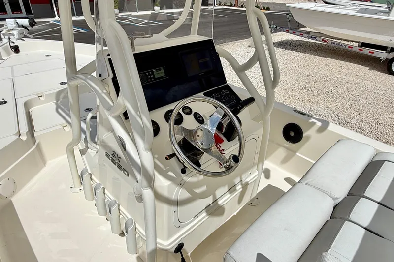 Slide: The Image of 2018 Skeeter SX2250 boat interior with steering wheel and seating area. - 14