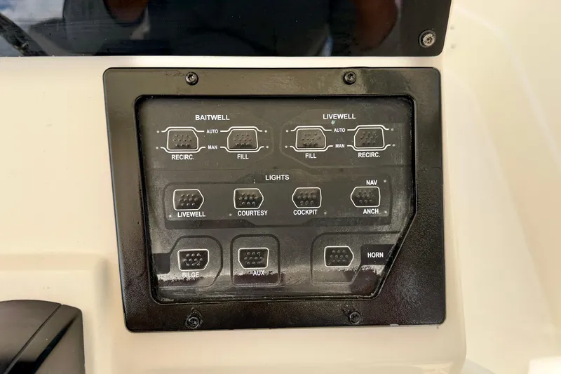 Slide: The Image of Control panel of a 2018 Skeeter SX2250 boat, featuring switches for baitwell and livewell. - 18
