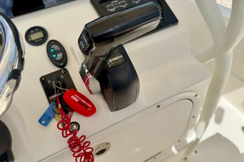 Slide: The Image of Control panel of a 2018 Skeeter SX2250 boat with Yamaha throttle and safety lanyard. - 19