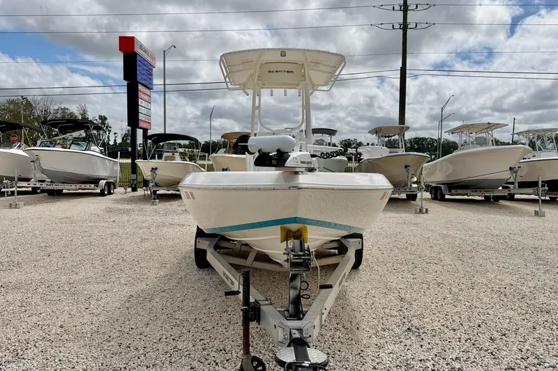 Slide: The Image of 2018 Skeeter SX2250 boat on trailer in dealership lot, surrounded by other boats. - 2