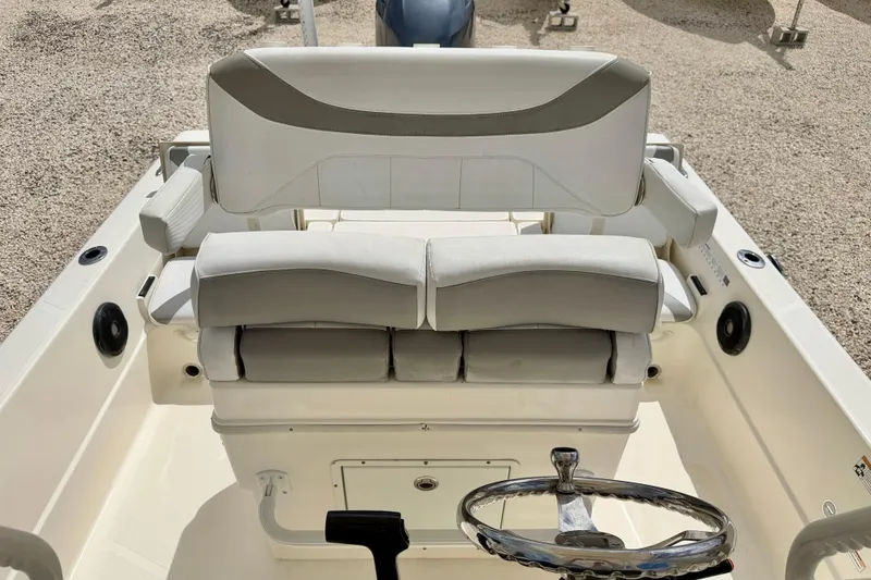 Slide: The Image of 2018 Skeeter SX2250 boat interior with cushioned seating and steering wheel. - 21