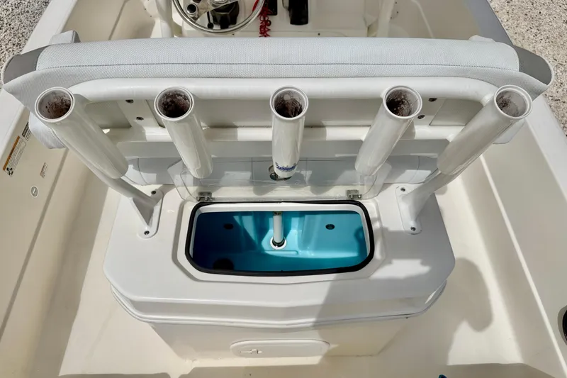 Slide: The Image of 2018 Skeeter SX2250 boat with rod holders and livewell, featuring a clean white and blue design. - 23