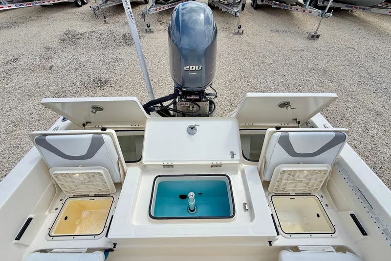 Slide: The Image of 2018 Skeeter SX2250 boat with open storage compartments and a 200 horsepower engine. - 25