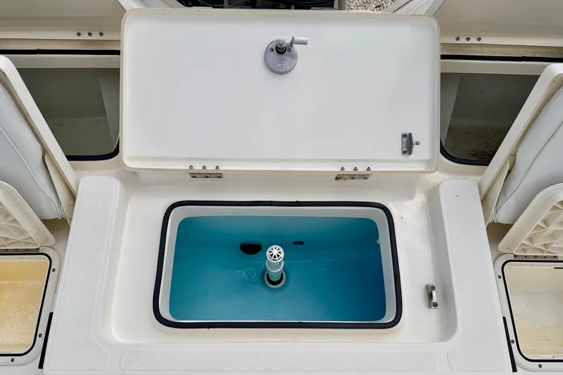 Slide: The Image of 2018 Skeeter SX2250 boat livewell with open lid, showcasing interior design. - 26