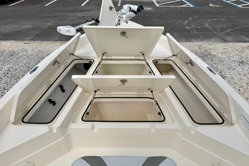 Slide: The Image of 2018 Skeeter SX2250 boat storage compartments open, showcasing ample space and organization. - 29
