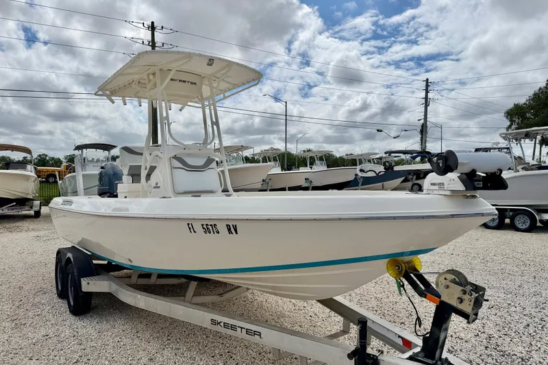 Slide: The Image of 2018 Skeeter SX2250 boat on trailer, parked outdoors under cloudy sky. - 3
