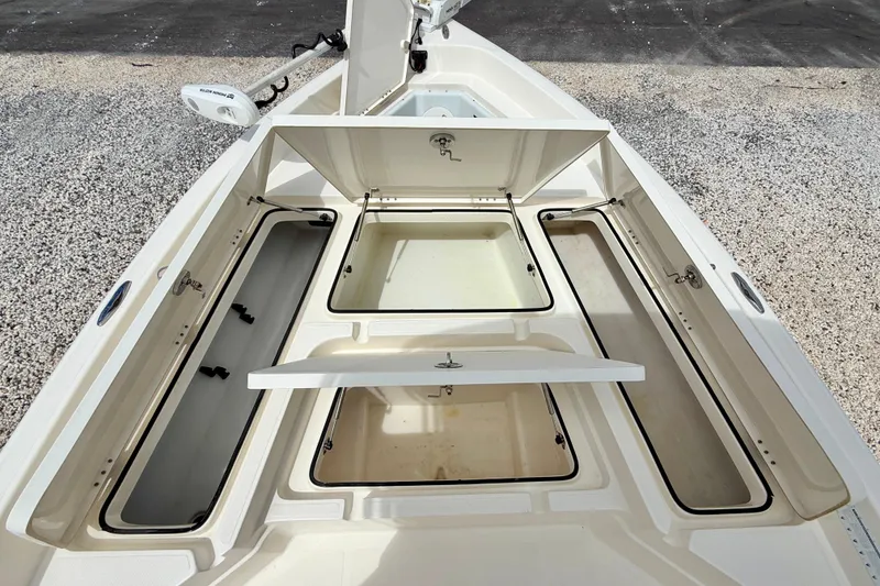 Slide: The Image of 2018 Skeeter SX2250 boat storage compartments open, showcasing spacious interior design. - 30