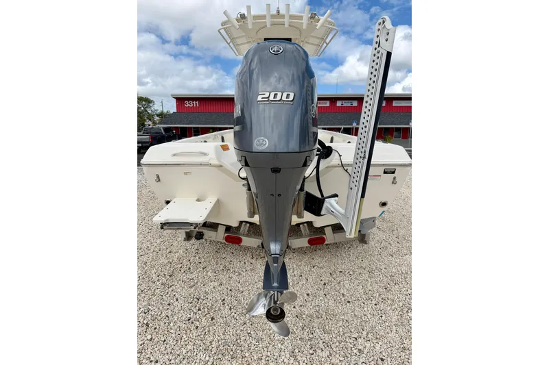 Slide: The Image of 2018 Skeeter SX2250 boat with Yamaha 200 outboard motor, parked on gravel. - 36